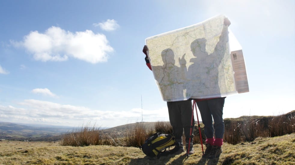 hikers holding map